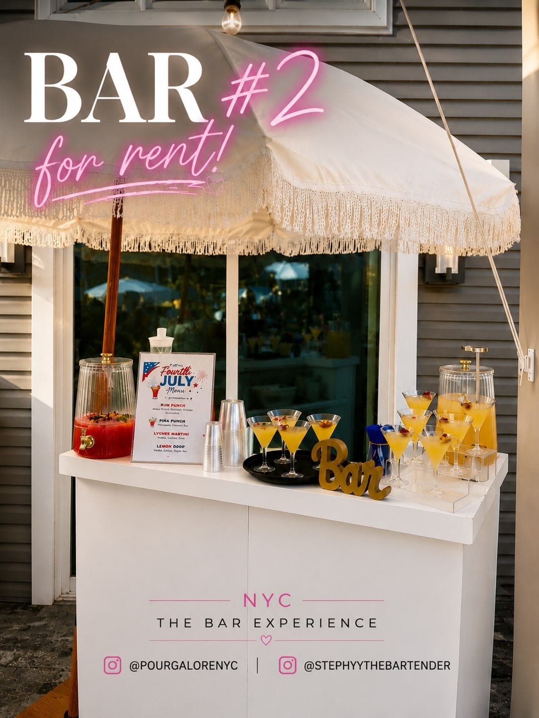 Bar #2 — white bar under a fringed cream umbrella, set with cocktails and dispensers